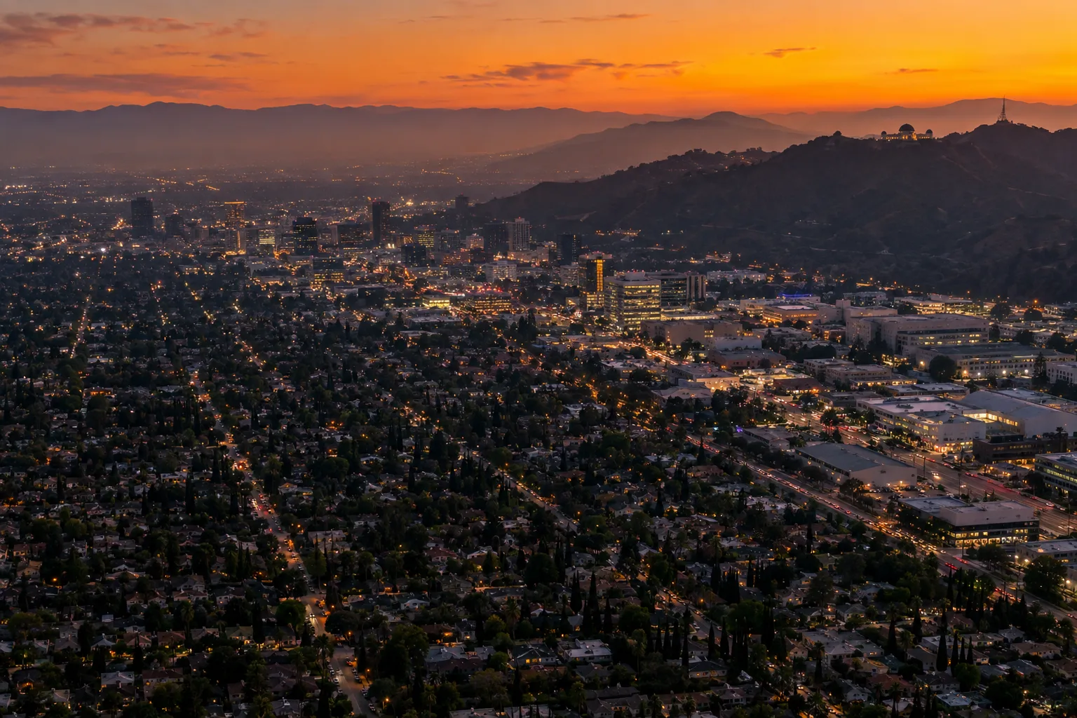 Aerial view of Los Angeles at sunset with the Griffith Park hills beyond